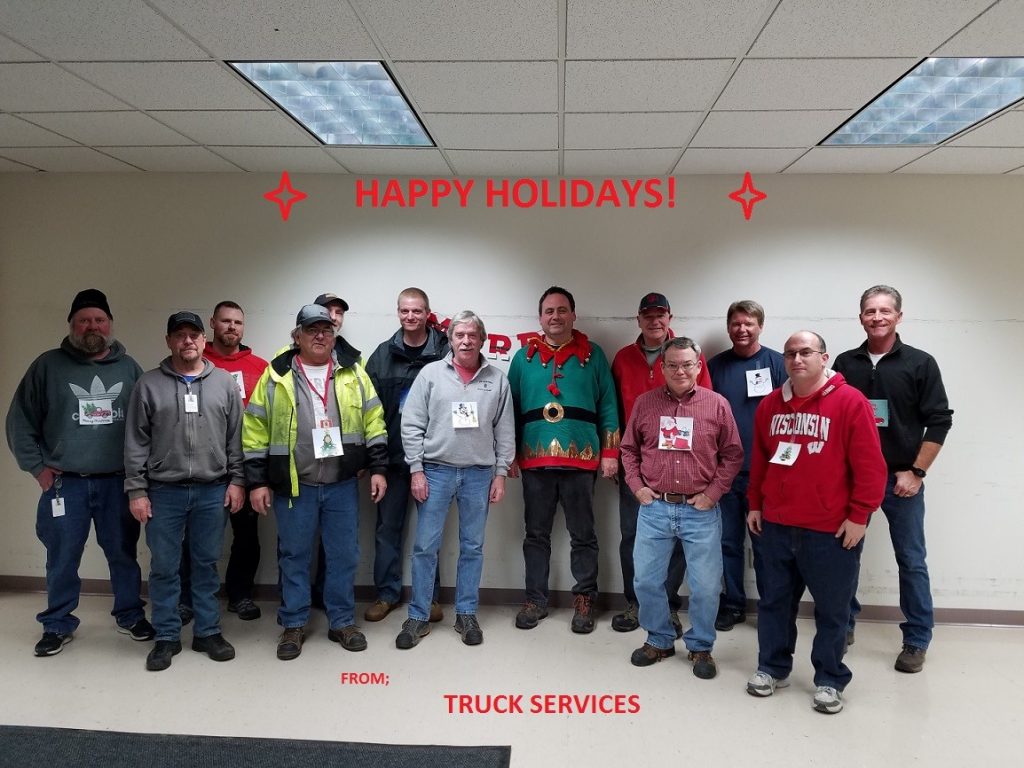 Truck Services staff pose for a photo in festive gear