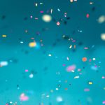 confetti falling in air on plain background