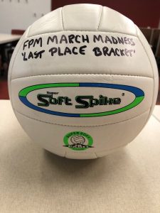 volleyball with official printed writing of brand: "Soft Spike" with other marker-written text that reads: "FPM MARCH MADNESS LAST PLACE BRACKET"