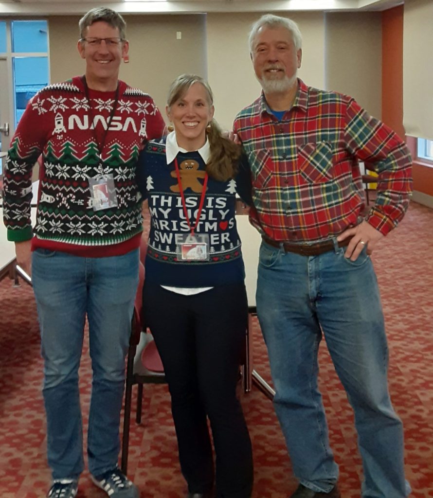 A picture of EHS Extended Leadership Team in their festive outfits at holiday party Jesse Decker, Andrea Ladd, Jeff Zebrowski